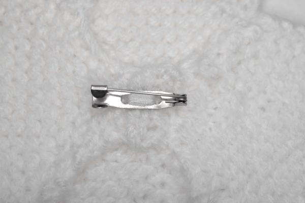 Hand knitted brooch in white
